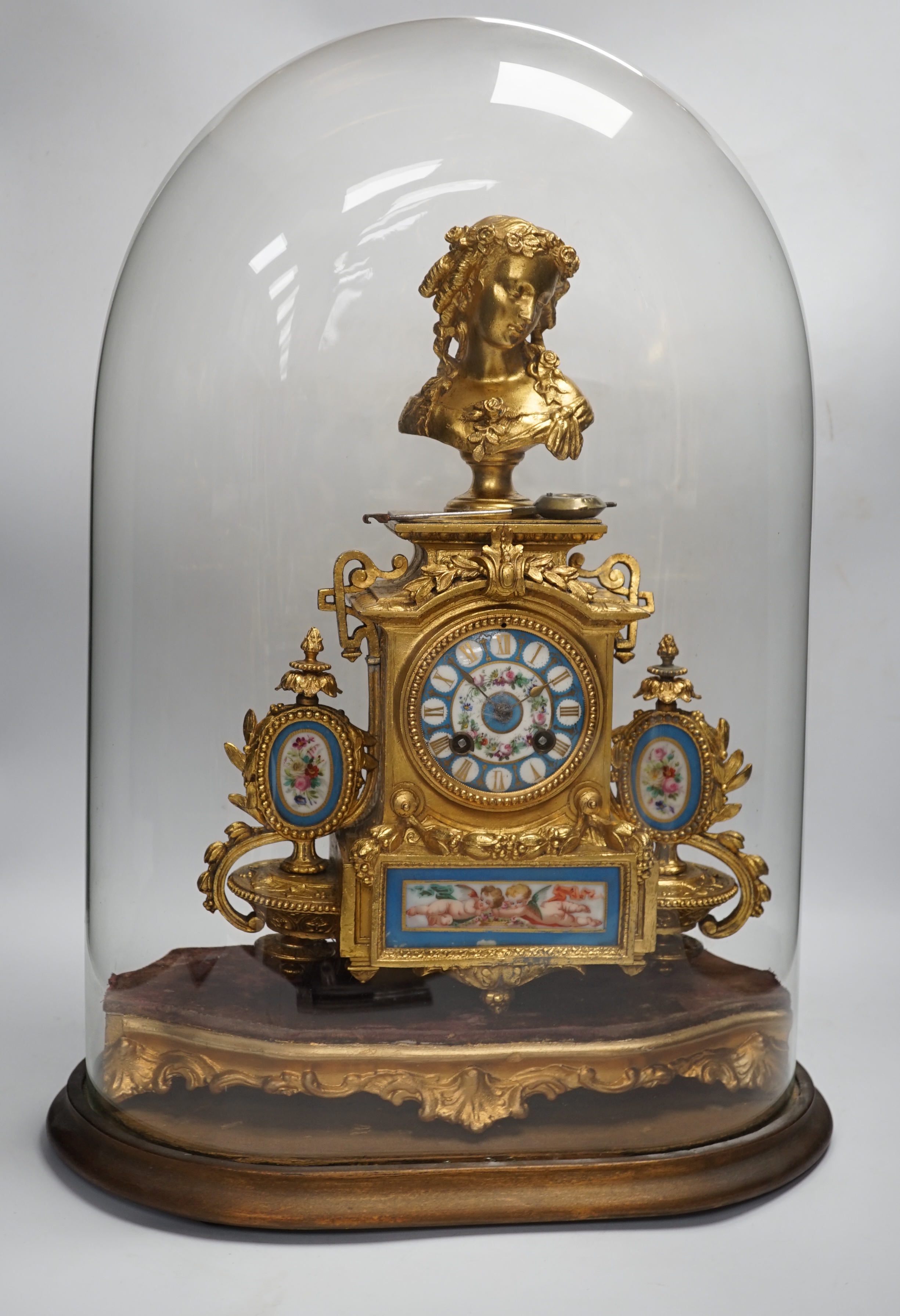 A late 19th century French gilt-spelter mantel clock with enamel panels, under glass dome, 54cm